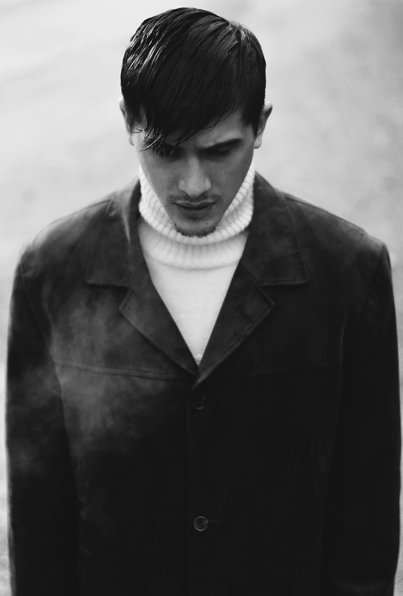 Portrait — young man in dark coat, black and white