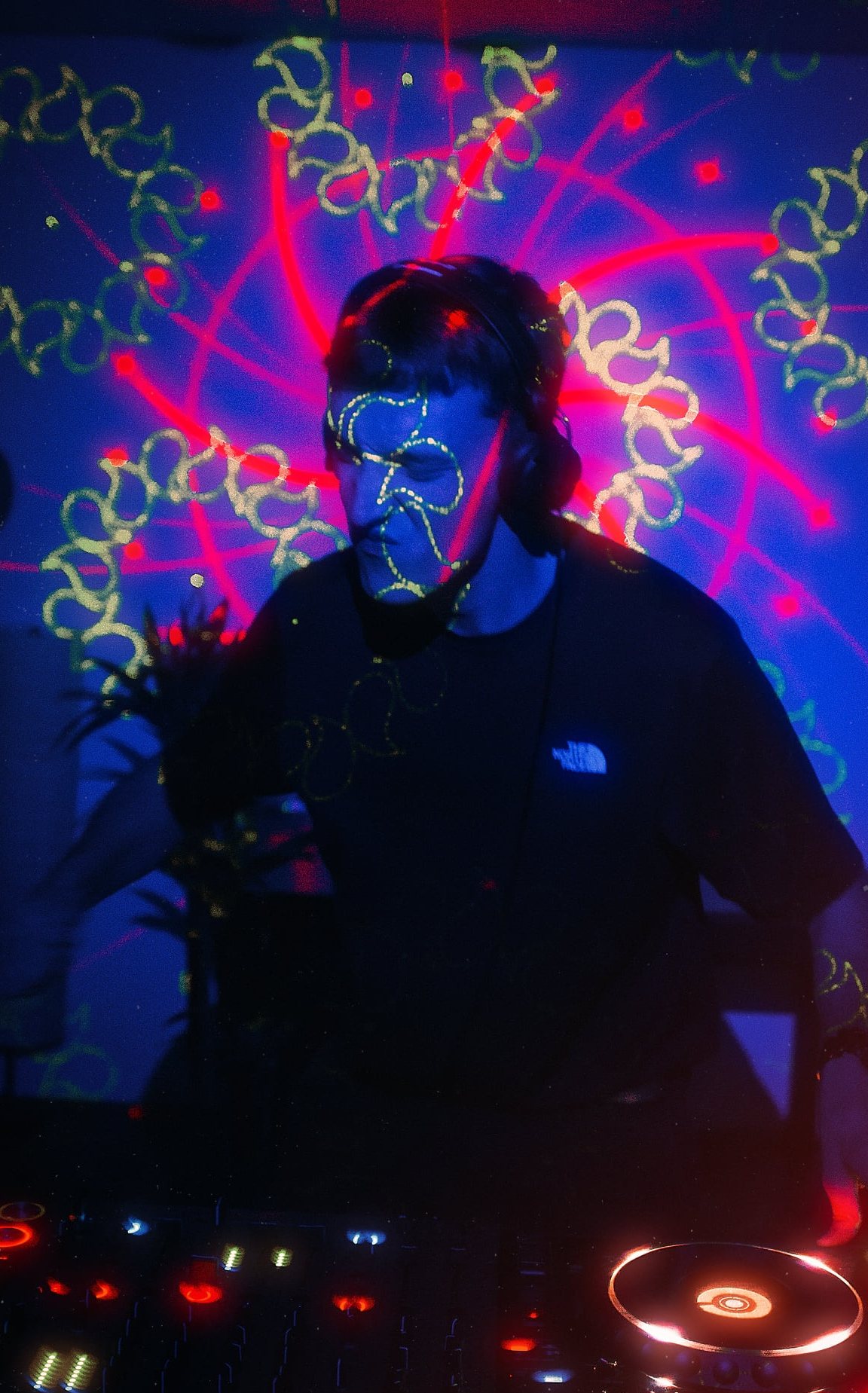 DJ under laser projections