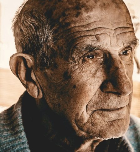 Close portrait of an old man, warm light