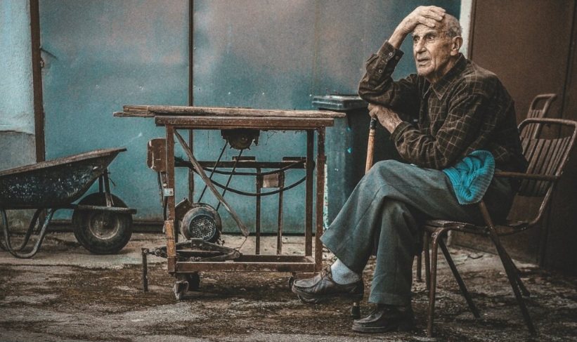 Old man sitting in a workshop