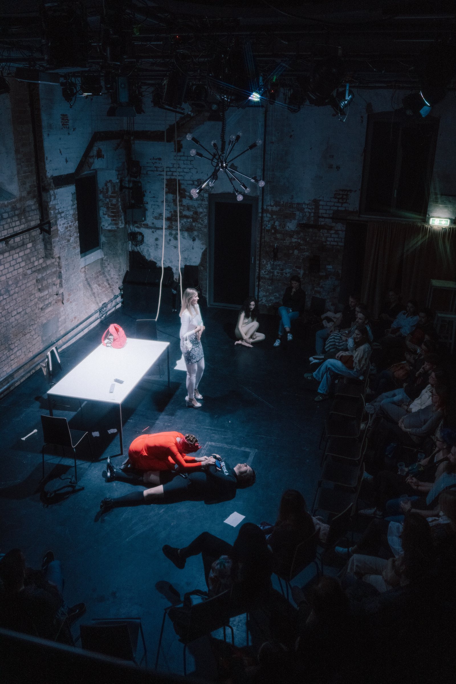 Theater stage seen from above, audience watching a scene