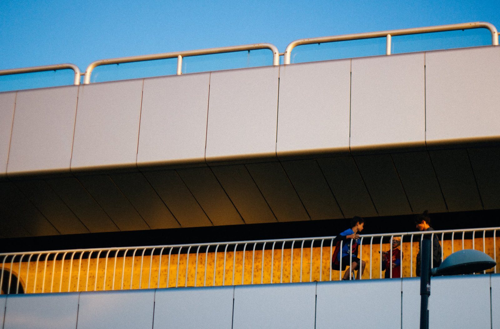 Kids on a footbridge at golden hour, Vienna