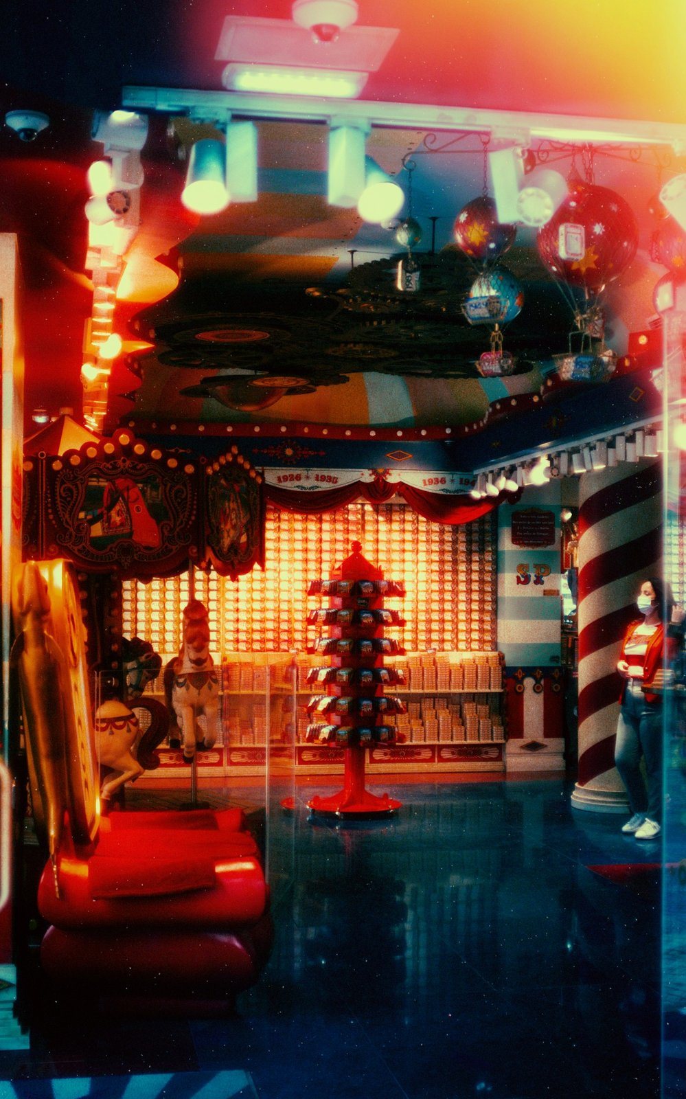 Candy shop interior with carousel horses and red light